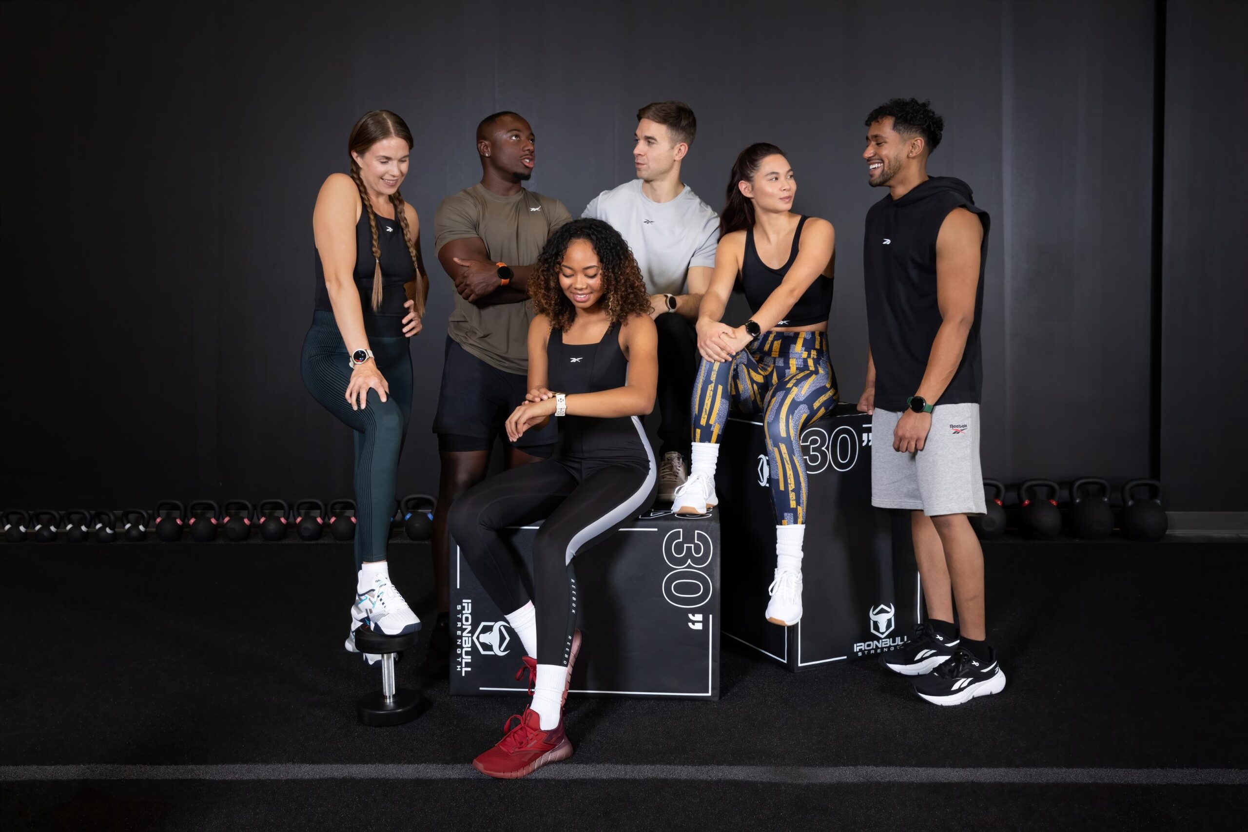 “Group of people wearing Reebok smartwatches in a gym.”